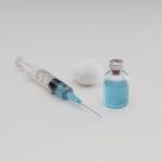 high-angle-syringe-with-cotton-vaccine-bottle